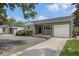Charming single-story home featuring a well-maintained front yard, attached garage, and welcoming curb appeal at 1920 Elmira St, Aurora, CO 80010
