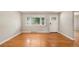 Bright living room featuring hardwood floors, neutral decor, and a large window with views of the neighborhood at 1920 Elmira St, Aurora, CO 80010