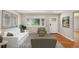 Bright living room featuring hardwood floors, neutral decor, and a large window with views of the neighborhood at 1920 Elmira St, Aurora, CO 80010