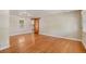 Hardwood floors, sliding wood door, neutral paint and ample lighting define this living room at 1920 Elmira St, Aurora, CO 80010