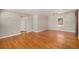 Spacious room with hardwood floors, neutral wall color and a sliding barn door and large window at 1920 Elmira St, Aurora, CO 80010