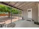Covered patio with ample space for outdoor seating, views of the backyard, and door to the house at 1920 Elmira St, Aurora, CO 80010