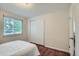 Well-lit bedroom with hardwood floors and a window at 5820 S Cherokee St, Littleton, CO 80120