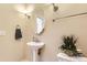 Bathroom featuring a pedestal sink, modern lighting fixtures, and a decorative plant at 3866 S Dallas Cir # 12202, Aurora, CO 80014