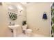 Bathroom featuring a pedestal sink, modern lighting fixtures, and a decorative towel rack at 3866 S Dallas Cir # 12202, Aurora, CO 80014