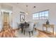 Dining room with wood-look floors, modern lighting, and a large window for natural light at 3866 S Dallas Cir # 12202, Aurora, CO 80014