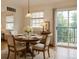 Cozy dining area with a round table, seating for four, and a sliding glass door to the balcony at 3866 S Dallas Cir # 12202, Aurora, CO 80014