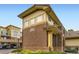 Angle view of condo featuring brick exterior, well-manicured landscaping, and clear signage at 3866 S Dallas Cir # 12202, Aurora, CO 80014