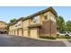A tan and brick townhome, with yellow garages at 3866 S Dallas Cir # 12202, Aurora, CO 80014