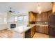 Kitchen with granite tile countertops, wooden cabinets, and stainless steel appliances at 3866 S Dallas Cir # 12202, Aurora, CO 80014
