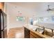 Bright kitchen with stainless steel sink, black appliances, and wood laminate flooring at 3866 S Dallas Cir # 12202, Aurora, CO 80014