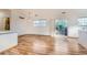Open living room featuring light wood floors, sliding glass doors to the balcony, a window, and light walls at 3866 S Dallas Cir # 12202, Aurora, CO 80014