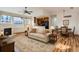 Spacious living room featuring a fireplace, large windows, and open access to the kitchen and dining area at 3866 S Dallas Cir # 12202, Aurora, CO 80014