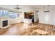 Open concept living room and kitchen with hardwood floors, gas fireplace, and ample natural light at 3866 S Dallas Cir # 12202, Aurora, CO 80014