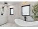 Luxurious bathroom with a soaking tub, modern fixtures, and natural light at 5700 S University Blvd, Greenwood Village, CO 80121