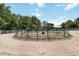 View of a green, steel-fenced horse pen with white fencing and natural landscaping at 5700 S University Blvd, Greenwood Village, CO 80121