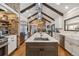 Modern kitchen with stainless steel appliances, a large island, and stylish lighting fixtures at 5700 S University Blvd, Greenwood Village, CO 80121