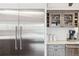 Close-up of a modern kitchen with stainless steel refrigerator and stylish cabinetry at 5700 S University Blvd, Greenwood Village, CO 80121