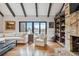 Bright living room with exposed beams, hardwood floors, and a cozy fireplace at 5700 S University Blvd, Greenwood Village, CO 80121