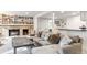 Spacious living room features a brick fireplace, built in shelving, and lots of seating at 5700 S University Blvd, Greenwood Village, CO 80121