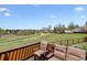 Comfortable seating on a deck overlooking a grassy field and walking path, a perfect outdoor experience at 17703 E Nassau Pl, Aurora, CO 80013