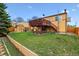 This backyard features a grassy lawn, a shed, and a charming wood fence, a great space at 17703 E Nassau Pl, Aurora, CO 80013
