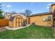 The backyard presents a storage shed with a grassy lawn, offering space for storage and outdoor relaxation at 17703 E Nassau Pl, Aurora, CO 80013