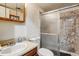 Bathroom features a standard toilet, sink, and shower with sliding glass doors, a great practical bathroom at 17703 E Nassau Pl, Aurora, CO 80013