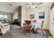 Open-concept dining area adjacent to living room with stone fireplace at 17703 E Nassau Pl, Aurora, CO 80013