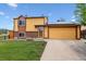 Charming home featuring a two-car garage, solar panels, and a well-maintained front yard at 17703 E Nassau Pl, Aurora, CO 80013