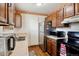 Traditional kitchen with wood cabinets and stainless steel appliances at 17703 E Nassau Pl, Aurora, CO 80013