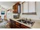 Functional kitchen featuring wood cabinets and a double sink with natural lighting at 17703 E Nassau Pl, Aurora, CO 80013