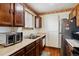 Functional kitchen features wood cabinets and stainless steel oven at 17703 E Nassau Pl, Aurora, CO 80013