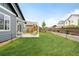 Spacious backyard featuring lush green grass and a patio area, perfect for outdoor relaxation at 577 Tristan Pl, Berthoud, CO 80513