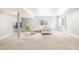 Spacious basement offers ample living space with neutral carpet and bright windows for natural light at 577 Tristan Pl, Berthoud, CO 80513