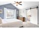 Bedroom boasts vaulted ceiling, and barn door access to a Primary bathroom with a neutral color palette at 577 Tristan Pl, Berthoud, CO 80513