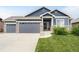 Charming single-Gathering home featuring a 3-car garage and a beautifully landscaped front yard at 577 Tristan Pl, Berthoud, CO 80513
