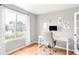 Bright home office with natural light, a modern desk, and hardwood floors at 577 Tristan Pl, Berthoud, CO 80513