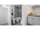 Bright bathroom featuring a tub with gray tile surround and a vanity with ample storage at 7600 Kearney Dr, Commerce City, CO 80022