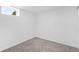 Cozy bedroom with a neutral carpet, a window, and a clean white wall at 7600 Kearney Dr, Commerce City, CO 80022