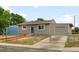 Charming single-story home features a fenced yard, attached garage, and neutral exterior paint at 7600 Kearney Dr, Commerce City, CO 80022