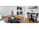 Open-concept living space with wood floors, a kitchen view, and stylish decor at 7600 Kearney Dr, Commerce City, CO 80022