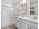 Modern bathroom features double vanity, framed mirrors, and tiled shower with glass door at 1836 Westport Ave, Berthoud, CO 80513