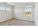 Bright bedroom featuring two windows with scenic views, and neutral carpeting at 1836 Westport Ave, Berthoud, CO 80513