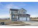 Charming two-story home with a stone and vinyl exterior, three car garage, and a covered front porch at 1836 Westport Ave, Berthoud, CO 80513