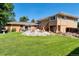 Expansive backyard showcasing well-maintained lawn and the home's exterior with an inviting patio area at 7930 S Kendall Ct, Littleton, CO 80128
