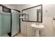 Functional bathroom featuring a pedestal sink and shower, ready for renovation and personalization at 7930 S Kendall Ct, Littleton, CO 80128