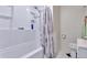Clean bathroom featuring a bathtub with shower, white fixtures, and modern showerhead at 7930 S Kendall Ct, Littleton, CO 80128