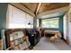 Charming bedroom featuring a wood-paneled ceiling and large windows offering plenty of natural light at 7930 S Kendall Ct, Littleton, CO 80128