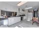 Bright kitchen featuring white cabinets, stainless steel appliances, and ample counter space at 7930 S Kendall Ct, Littleton, CO 80128